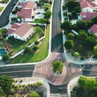 An aerial view of a residential area with houses and trees