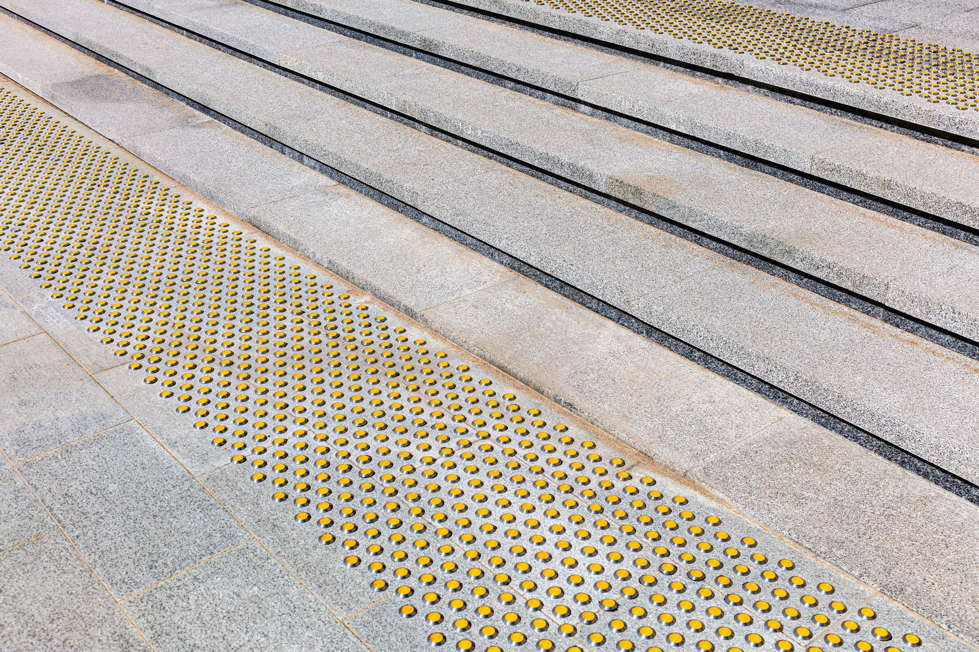 A close up of a set of stairs with yellow dots on them.