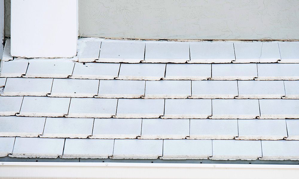A roof with white tiles and a white gutter