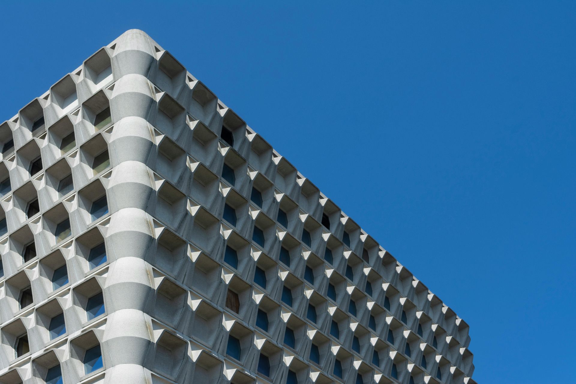 Looking up at a building with a blue sky in the background.