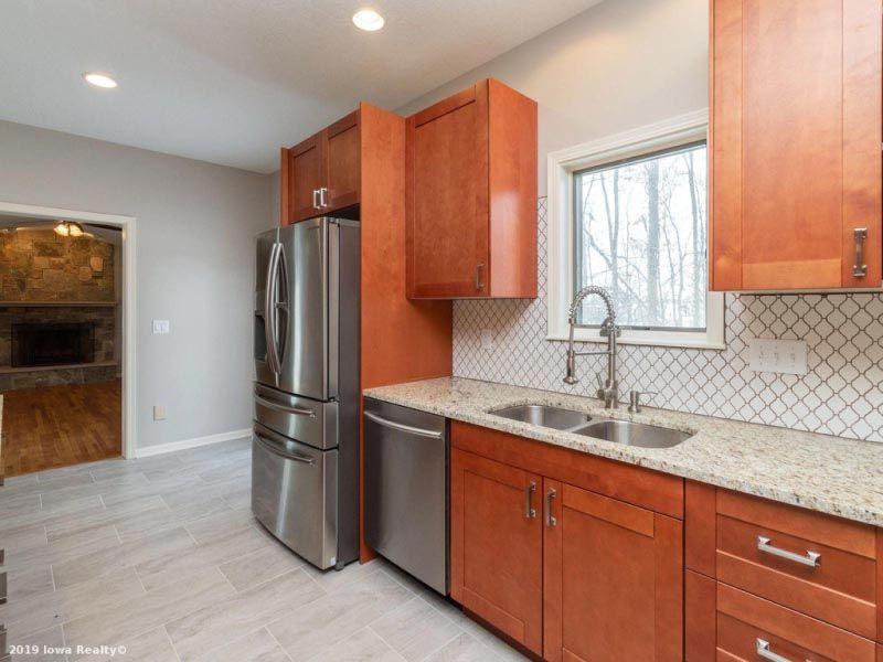 A kitchen with stainless steel appliances and wooden cabinets.