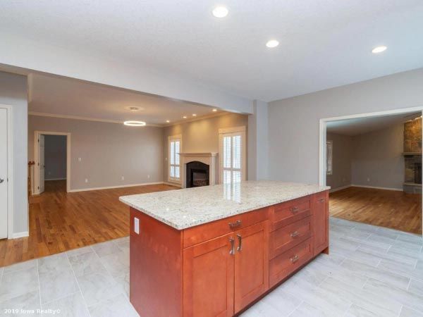 A kitchen with a large island and granite counter tops