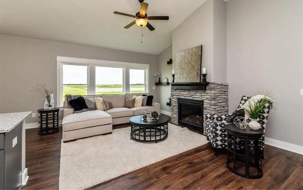A living room with a couch , chair , coffee table and fireplace.