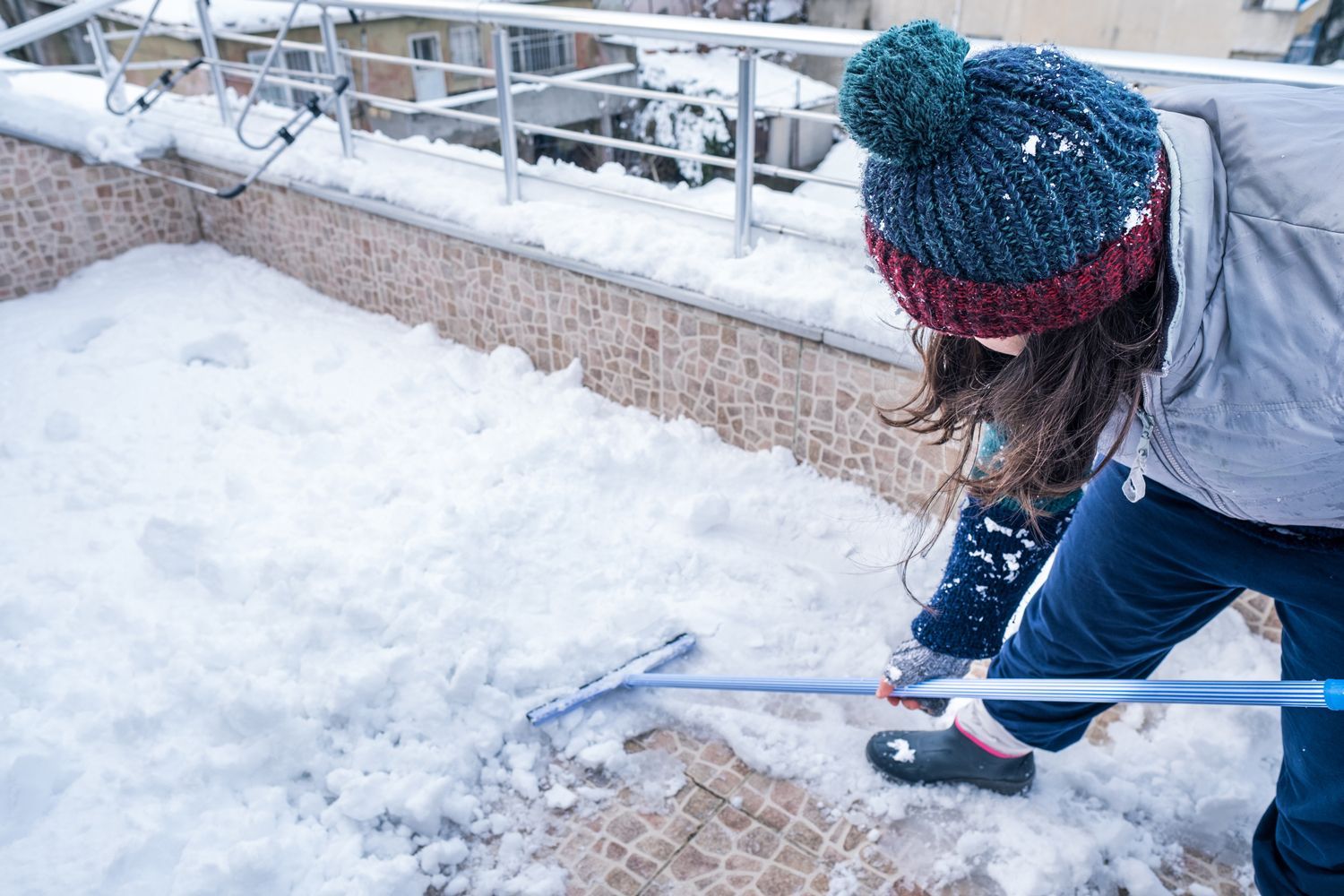 Woman Shoveling Snow — Chelsea, ME — AK Lawn & Landscape LLC