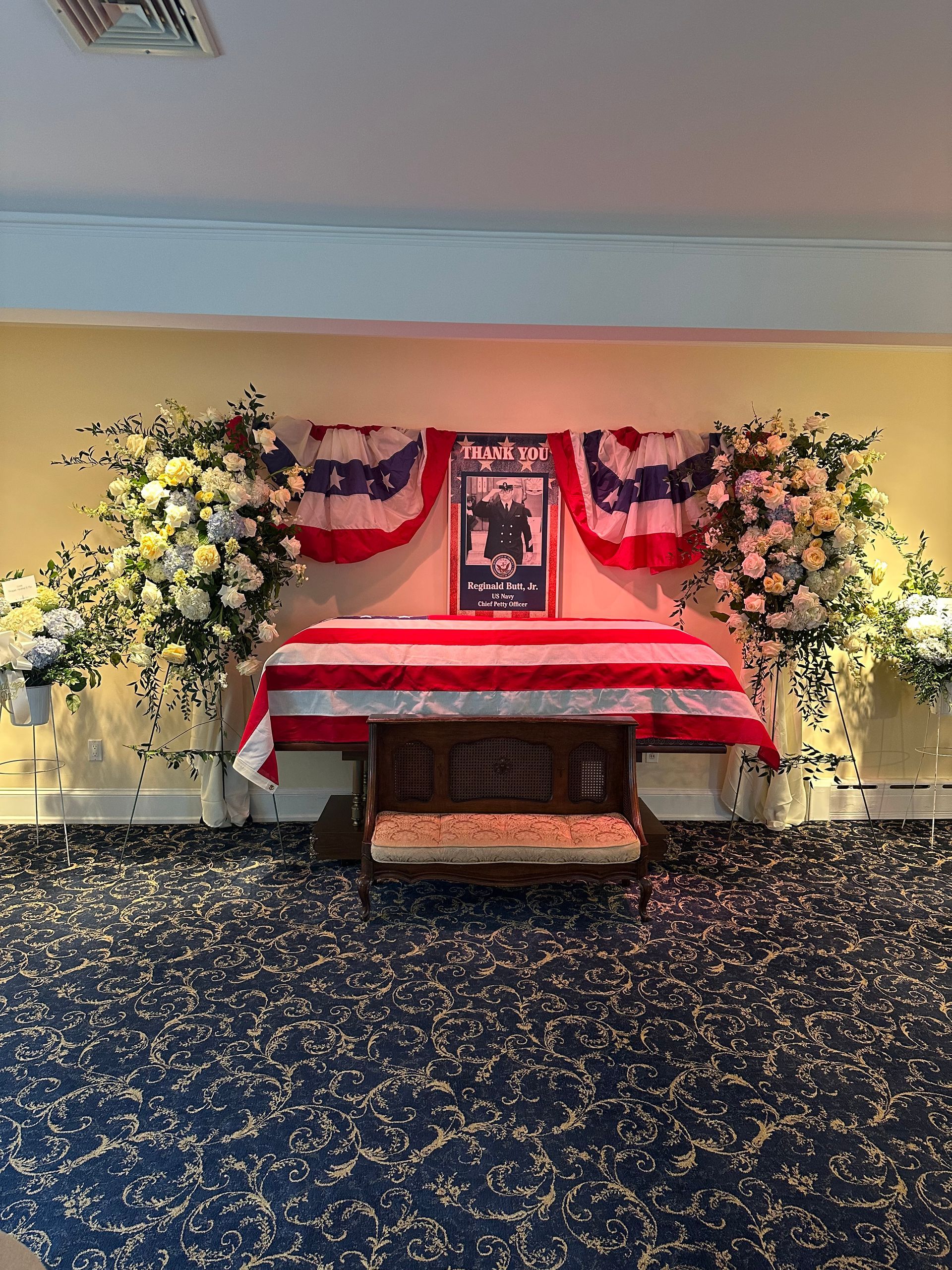 A man in a military uniform salutes in front of a cemetery