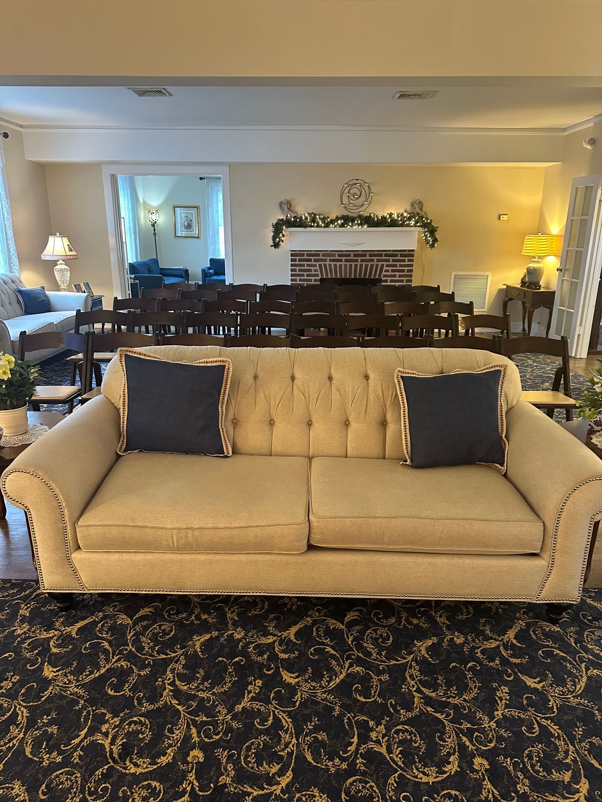 A fountain in a park with palm trees in the background