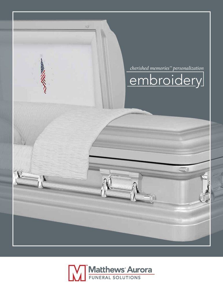 Silver casket with American flag embroidery.
