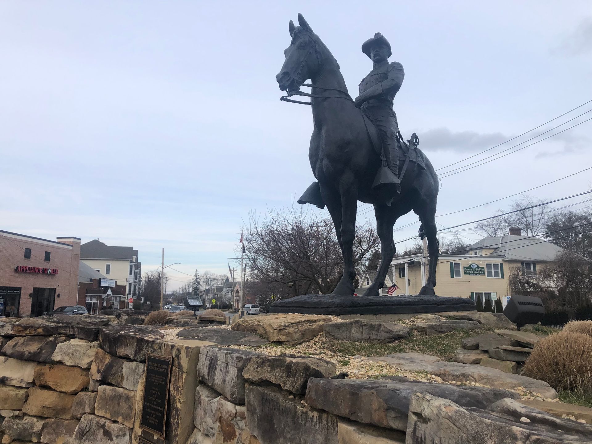 A large white building with a brown roof and a lot of windows.