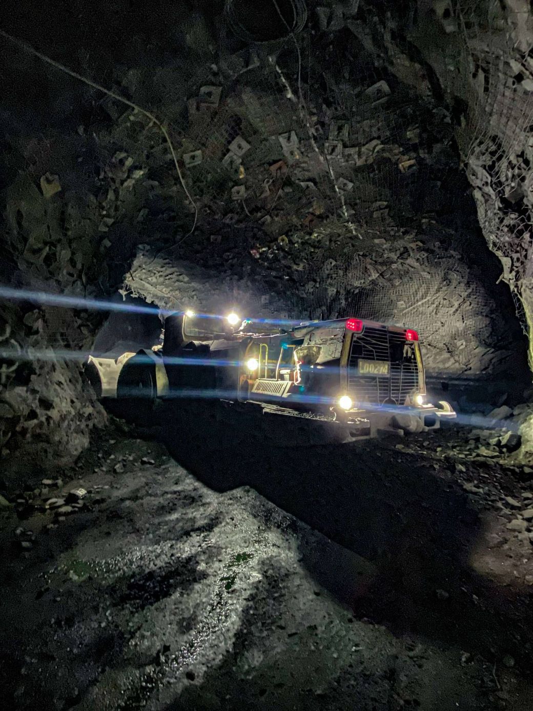 A underground bogger is driving through an underground mine after being fixed by GDS.