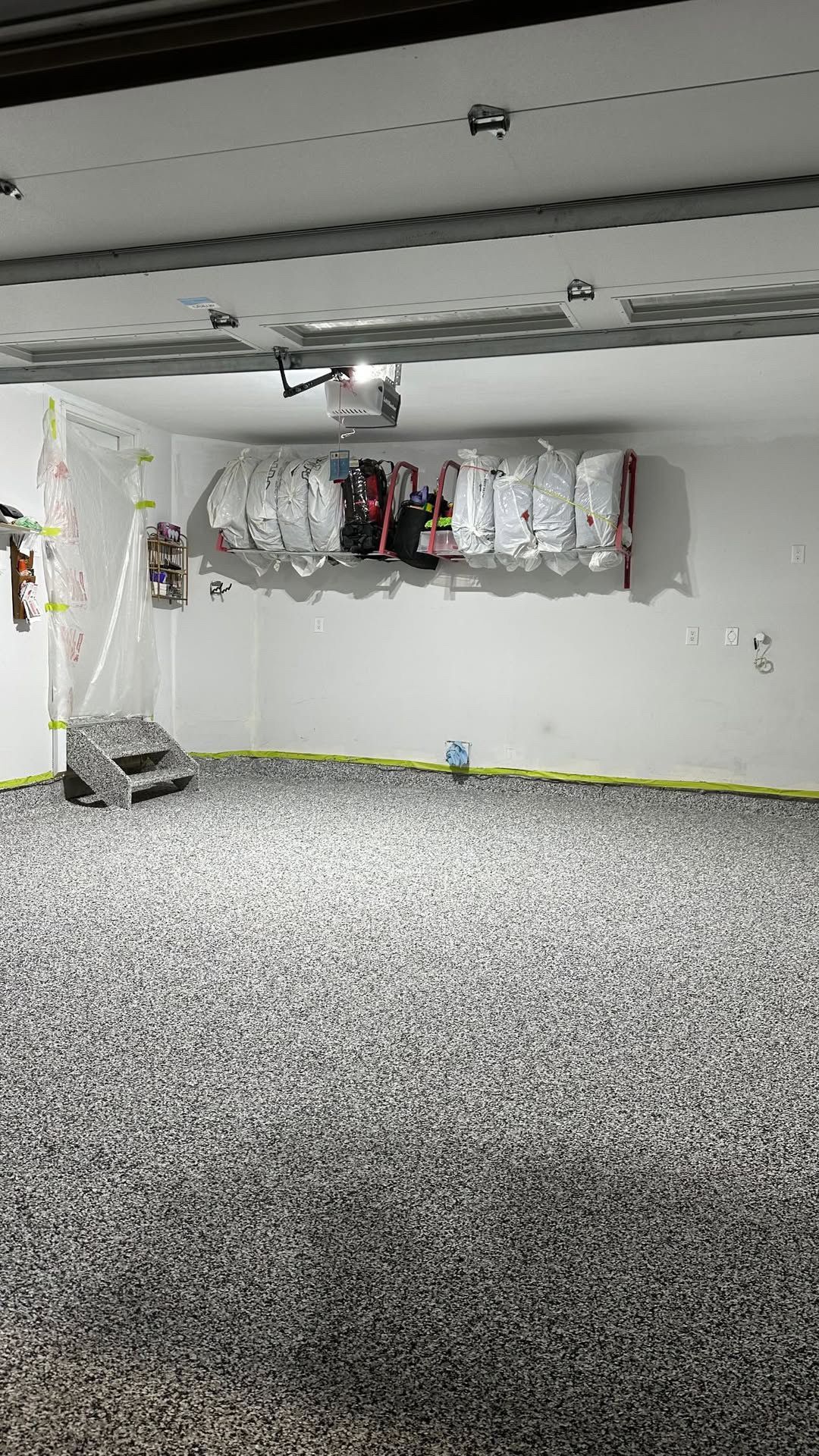 A garage with a lot of balloons hanging from the ceiling.