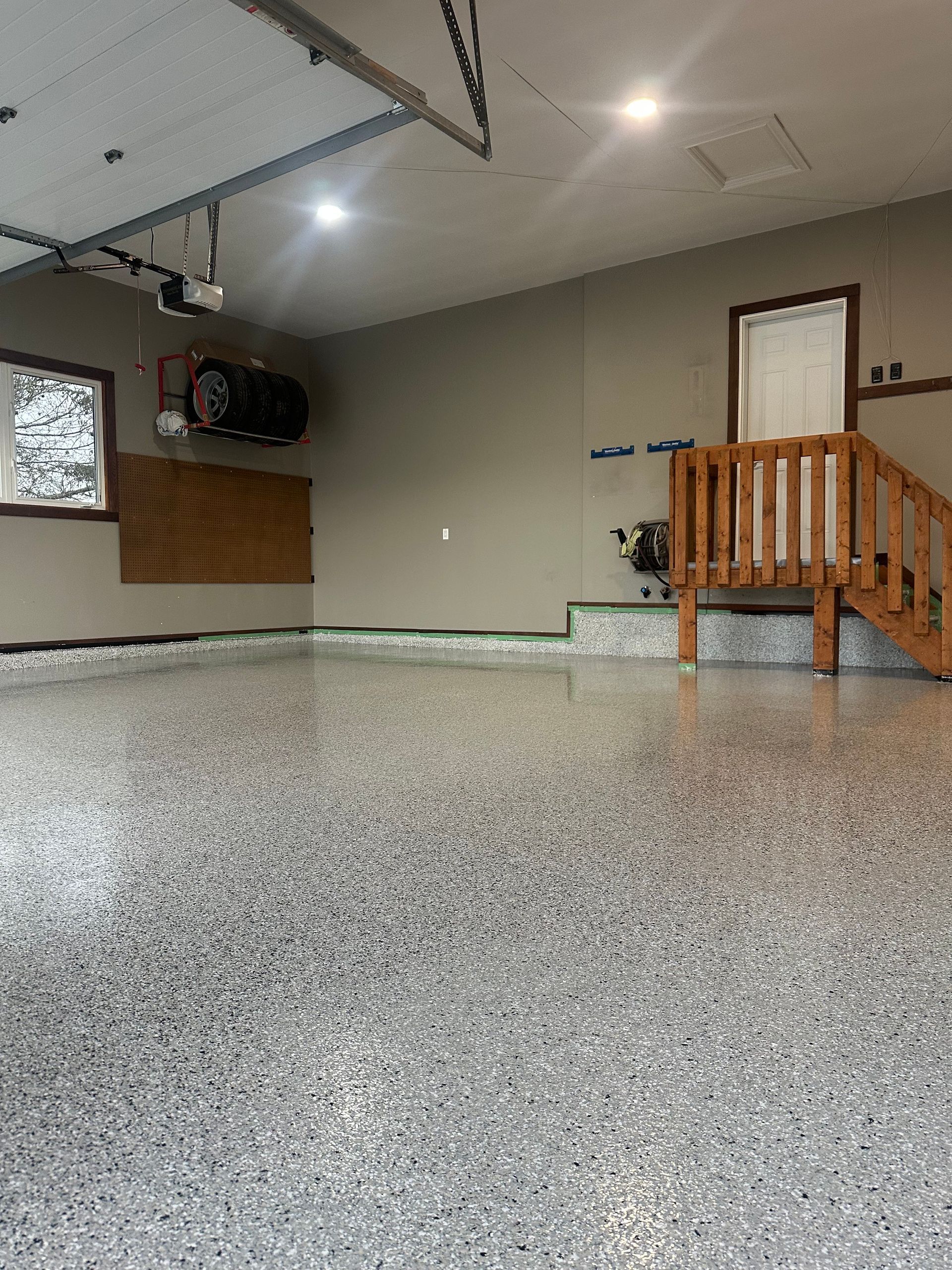 A garage with a staircase leading up to the second floor.