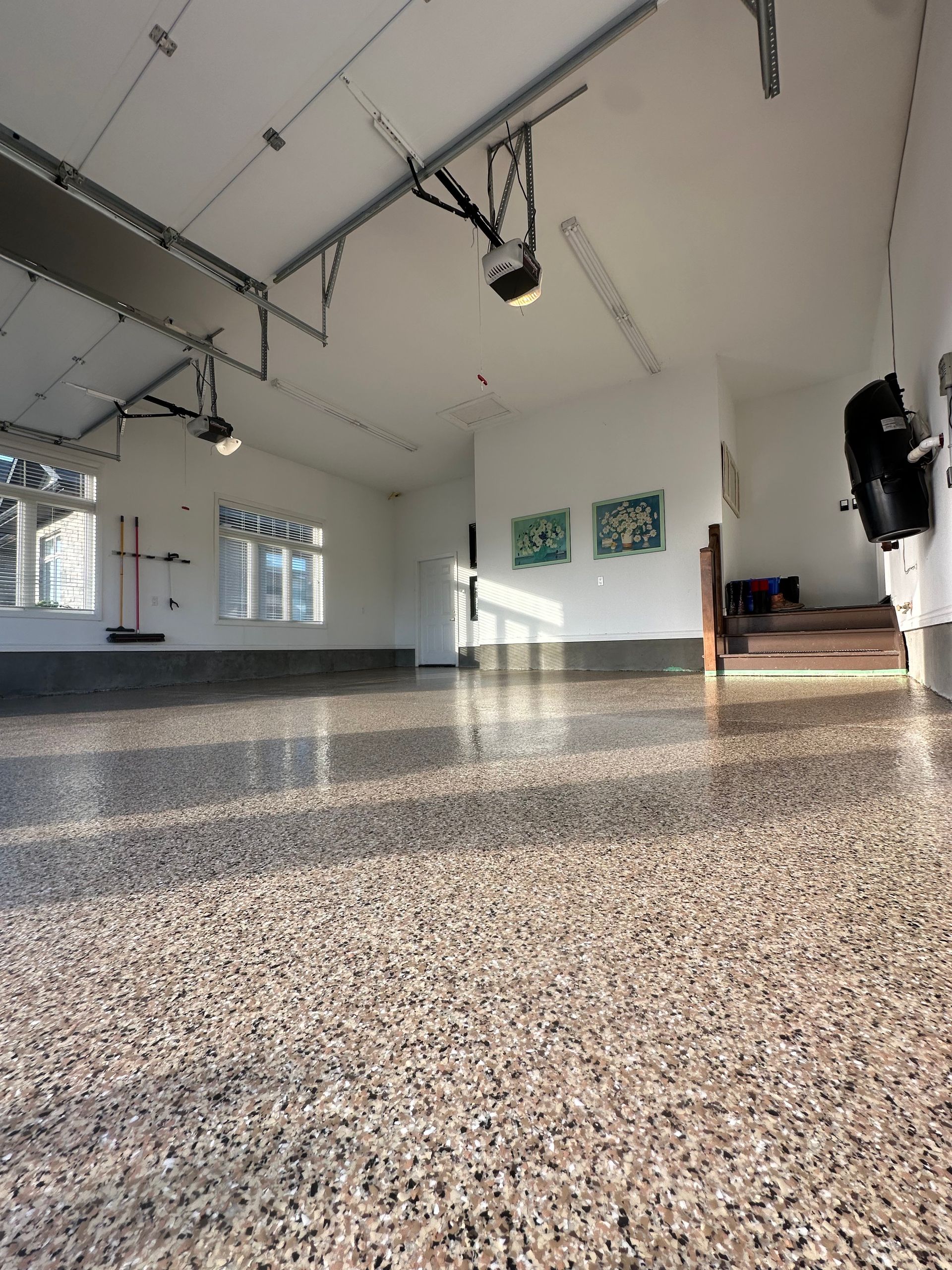 A garage with a concrete floor and a garage door opener