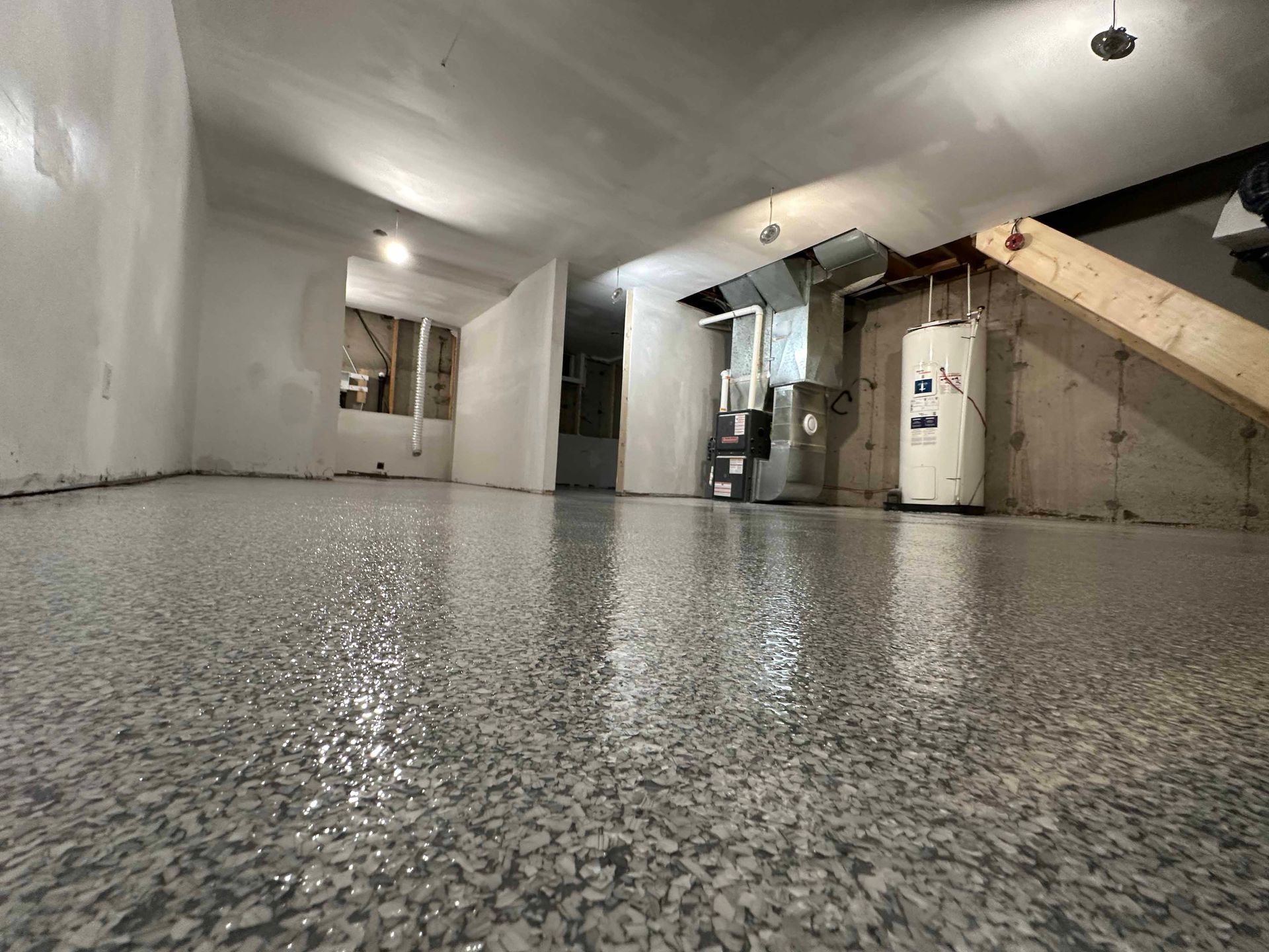 A close up of a garage floor with a lot of small stones on it.