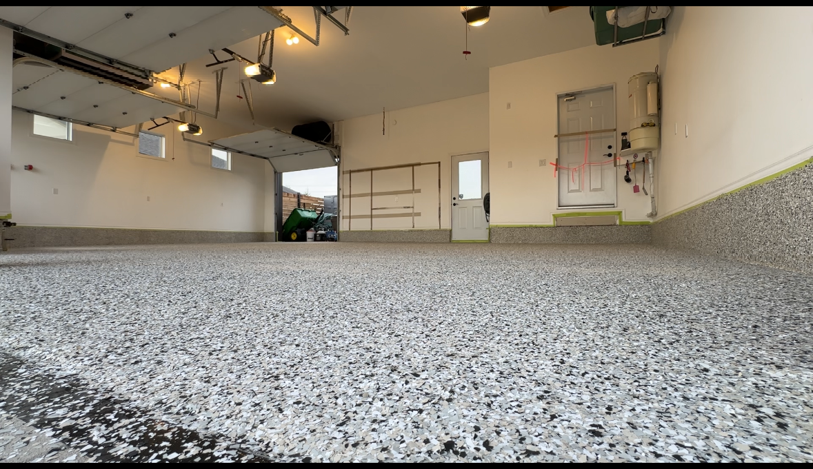 A garage with a gray floor and white walls.