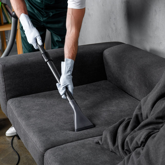 Man Cleaning Sofa - Greenville, NC - Jansen Upholstery & Carpet Cleaning