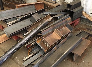 Long iron piled up at a scrap yard.