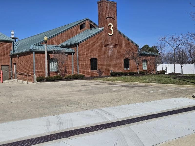 A large brick building with the number 3 on it