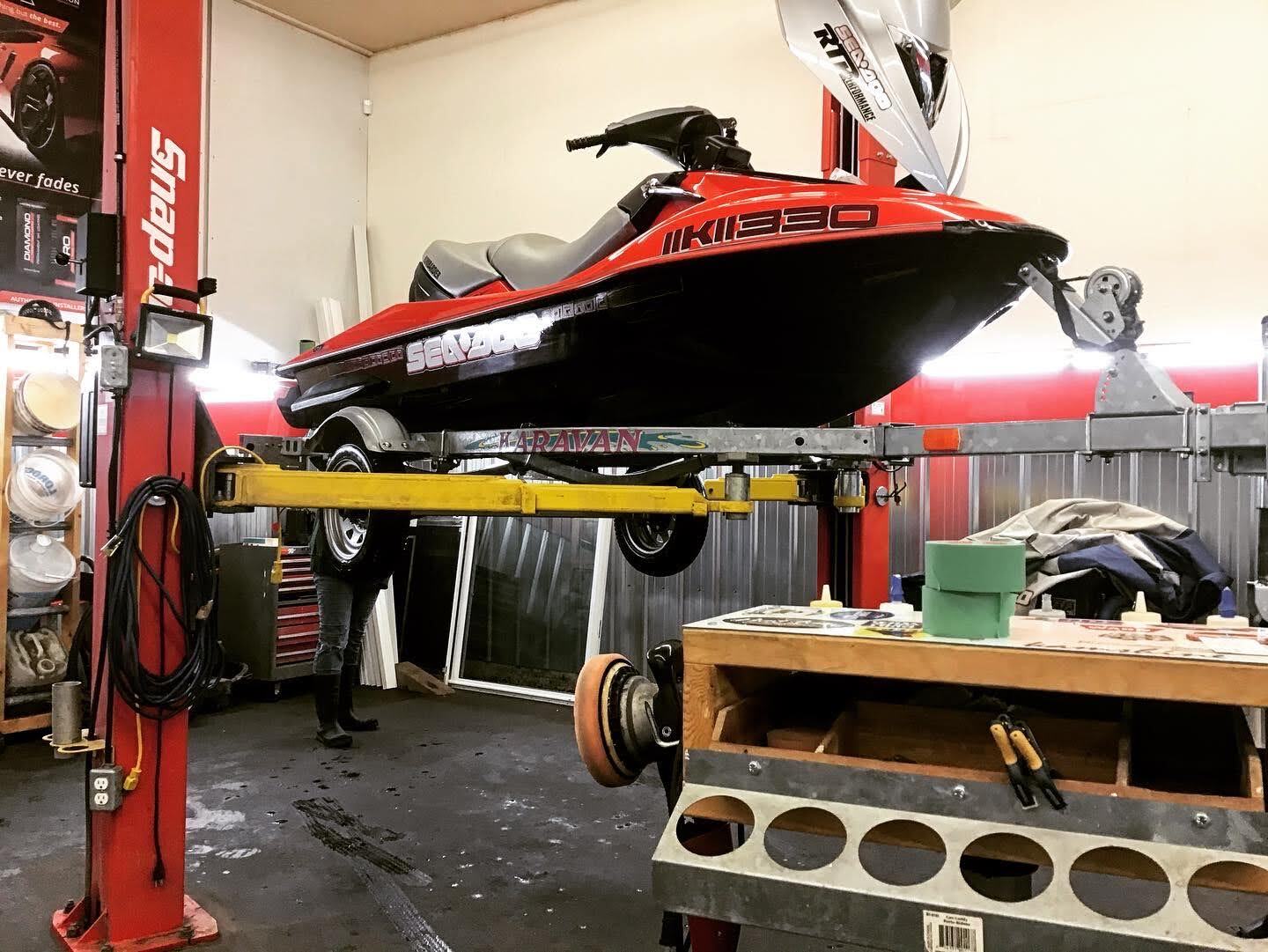 Red Boat Installing Decals — Kamloops, BC — Kamshine Automotive Detailing Ltd.