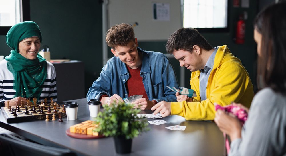 Four People At A Table, Playing Cards And Chess — Side By Side Support Services Casino in Casino, NSW