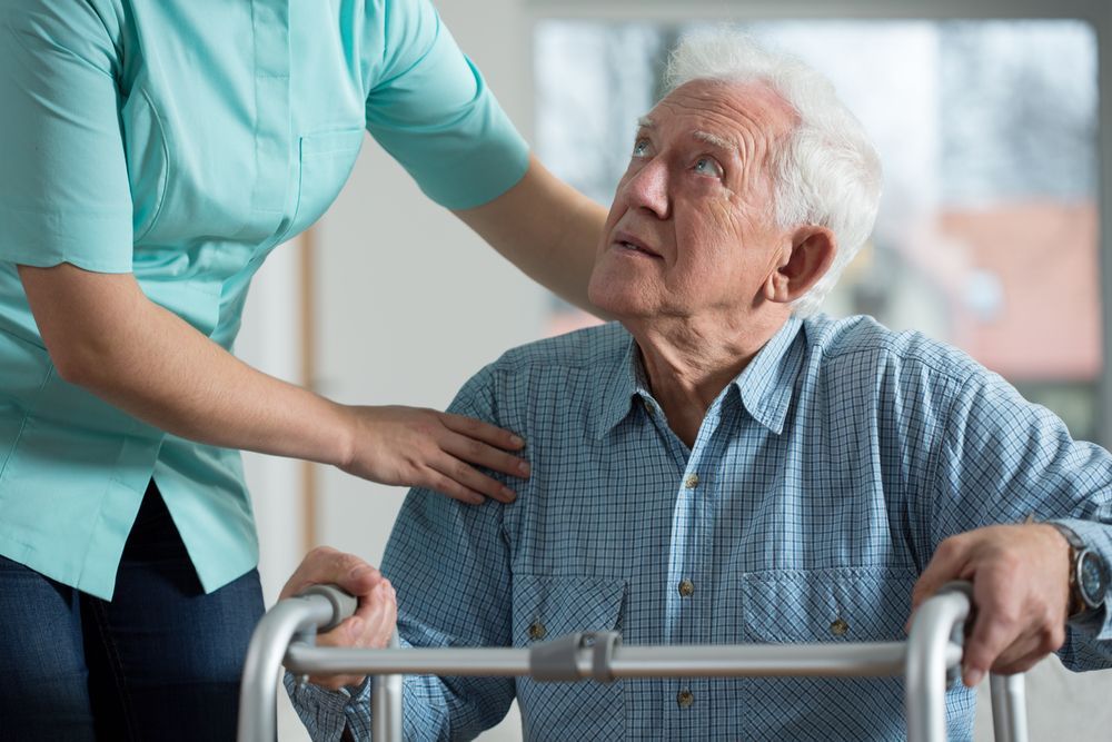 Caregiver Assisting An Elderly Person Using A Walker — Side By Side Support Services Casino in Kyogle, NSW