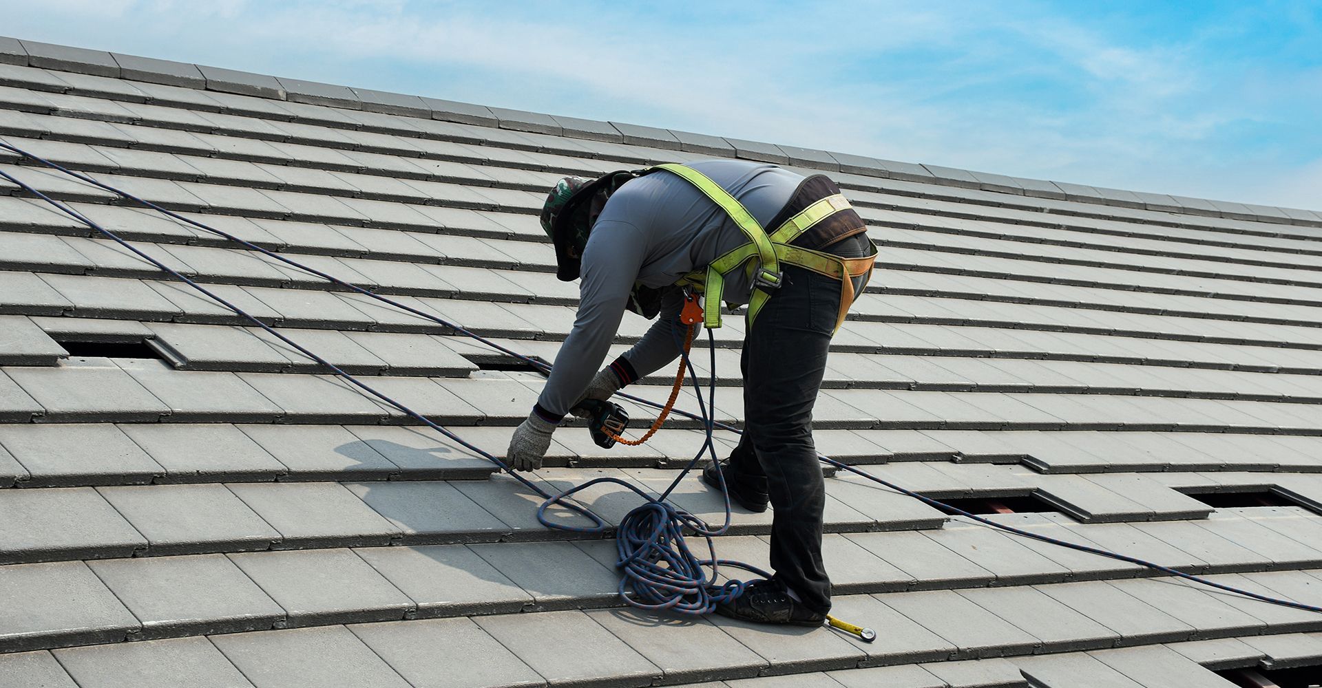 A man is working on the roof of a building.