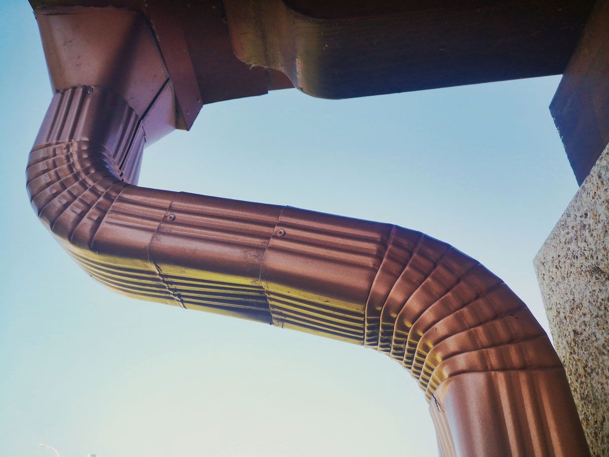 A close up of a copper gutter on a roof