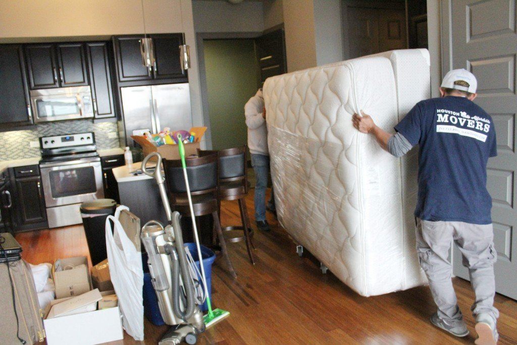 Movers moving a bed