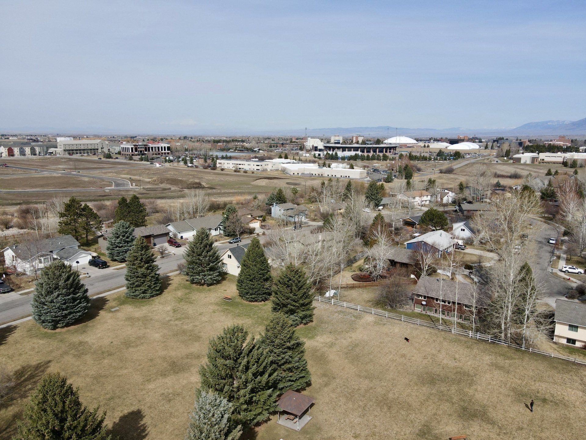 An aerial view of a residential area with trees and houses.