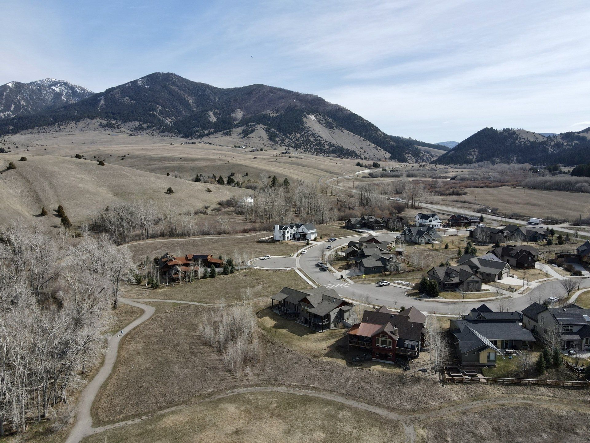 An aerial view of a residential area with mountains in the background
