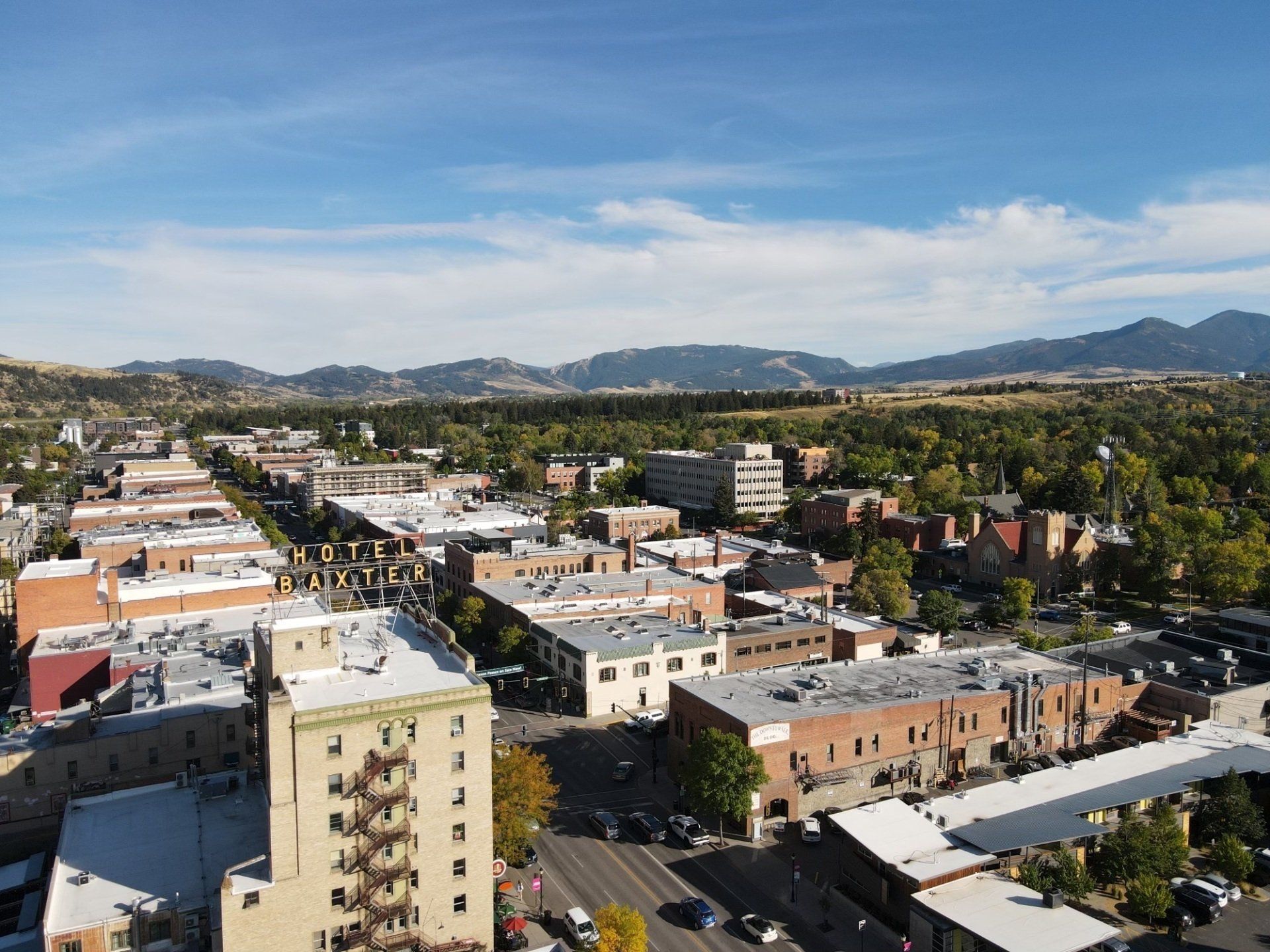 An aerial view of a city with mountains in the background