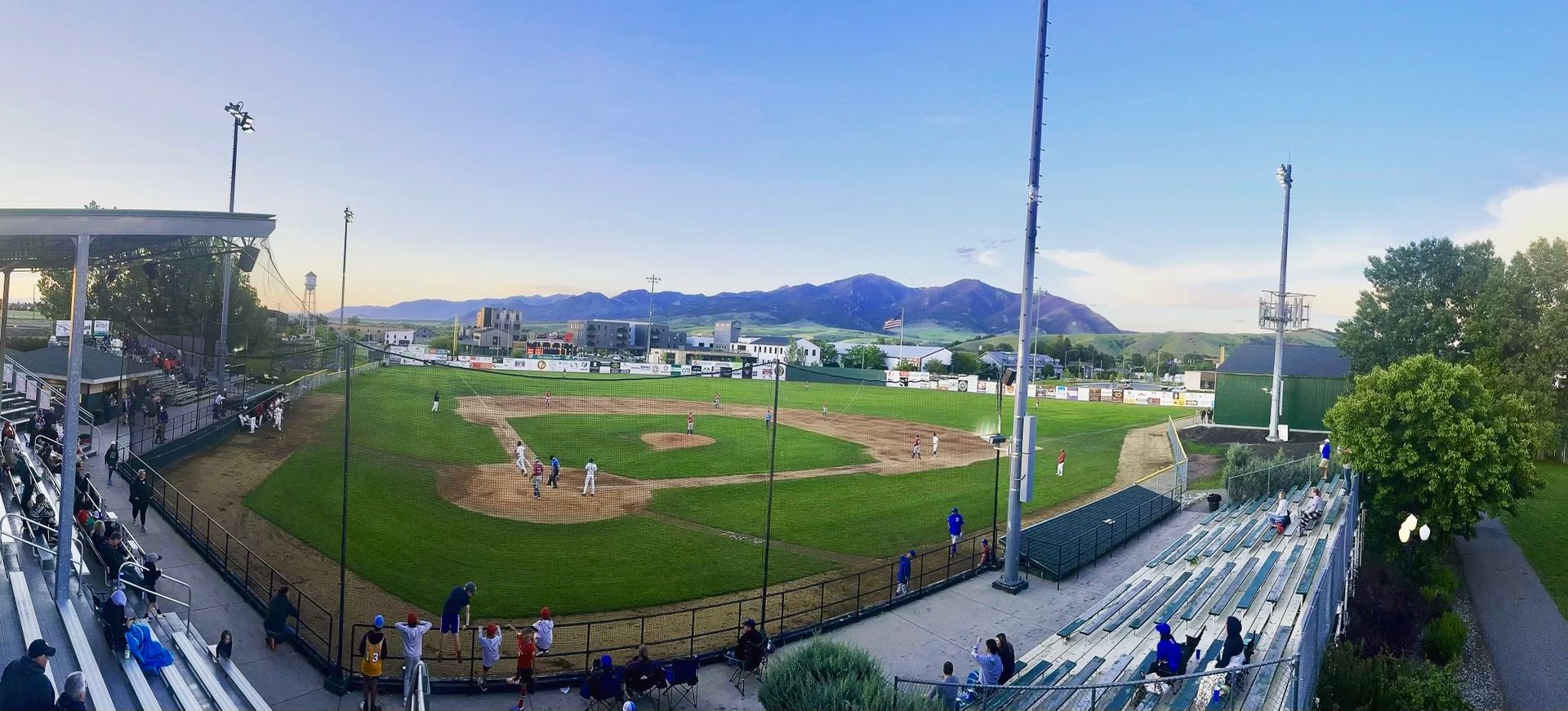 a view of a baseball pitch in Bozeman with the bridges in the background