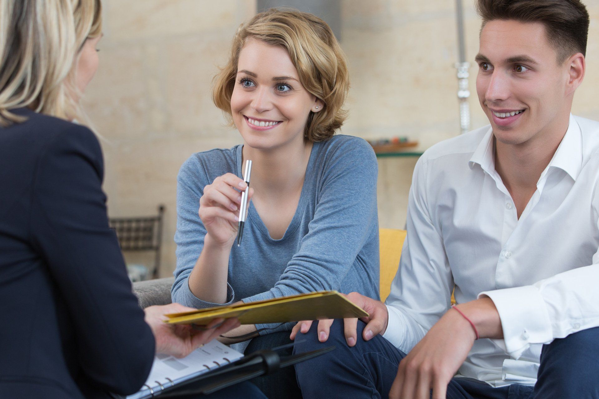 two women and a man chatting while sitting