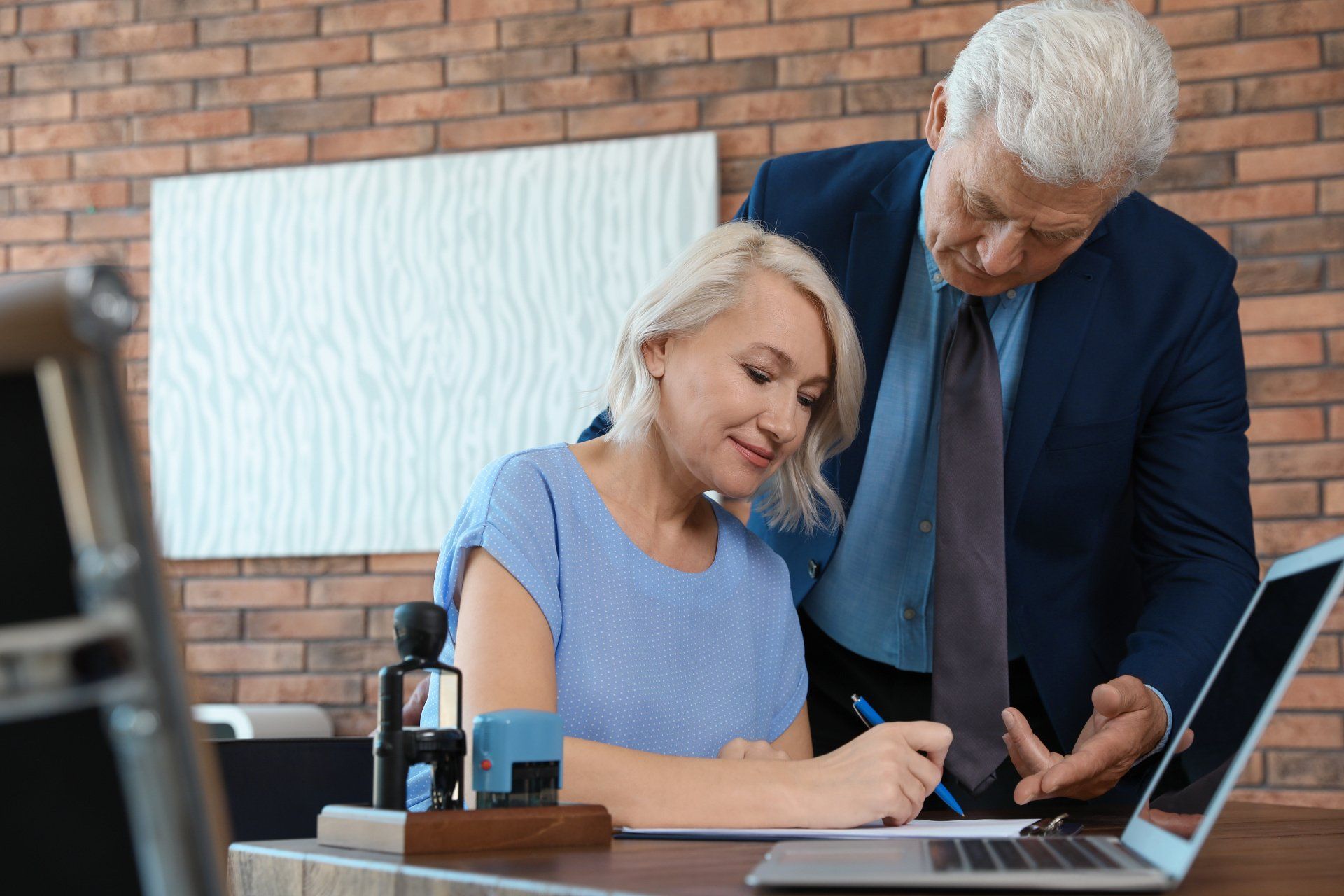 a man and a women signing some documents