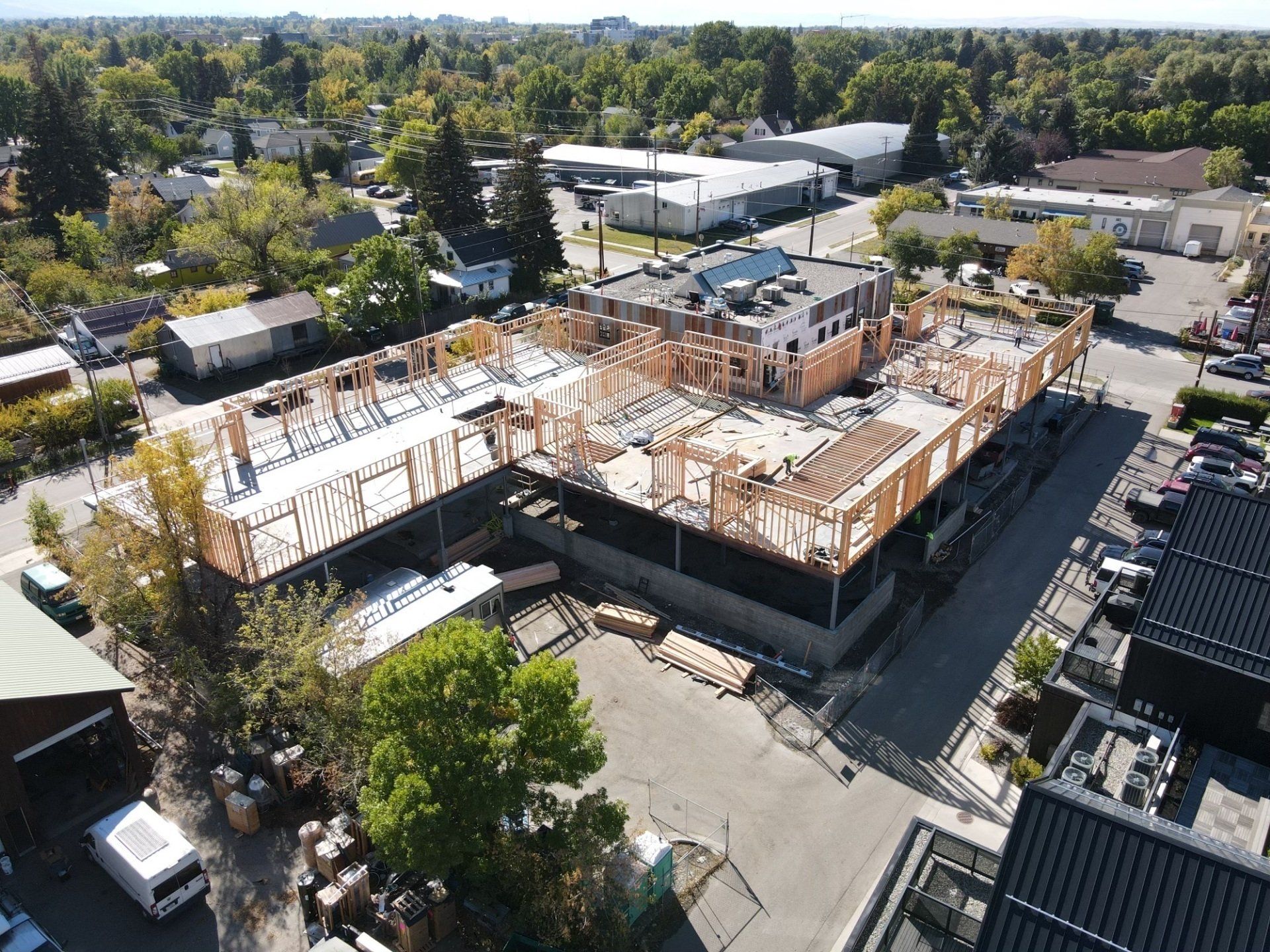 An aerial view of a building under construction in a city.