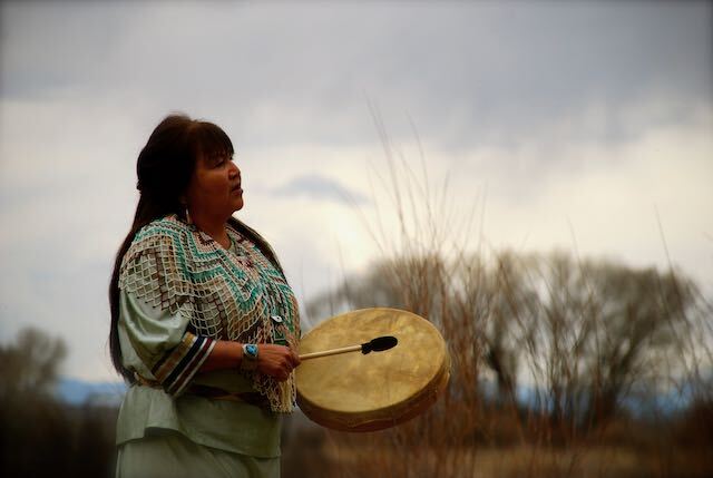 a ceromony being performed by jean white with a blurred. backround