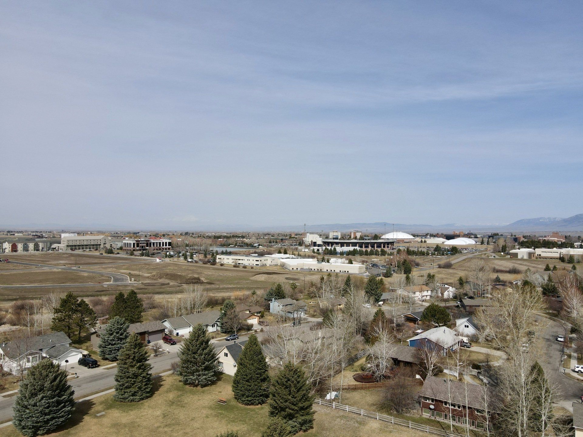 An aerial view of a small town with a lot of houses and trees.