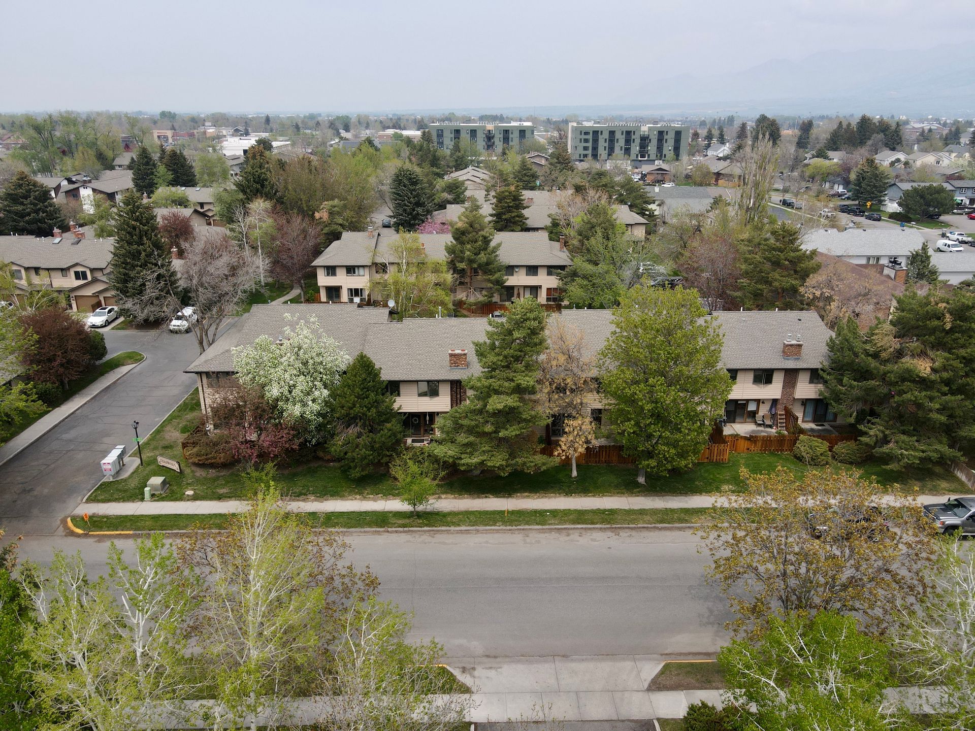 An aerial view of a residential area with houses and trees