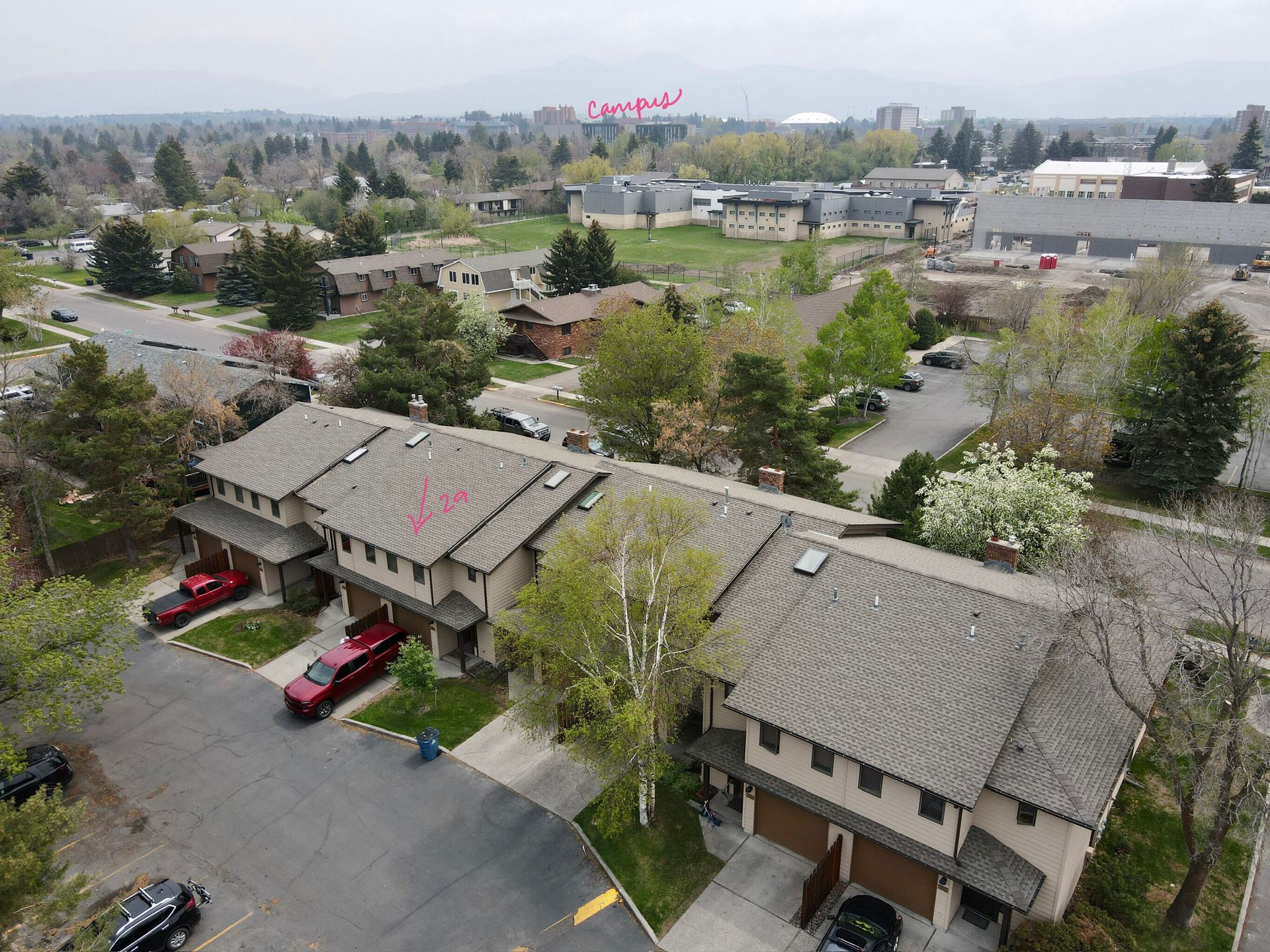 An aerial view of a residential area with a lot of houses and trees.