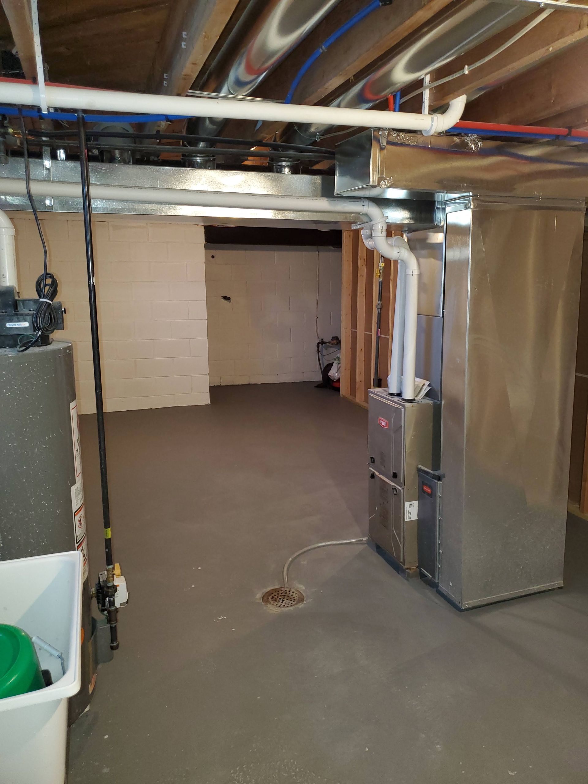 a basement with a furnace and a water heater .