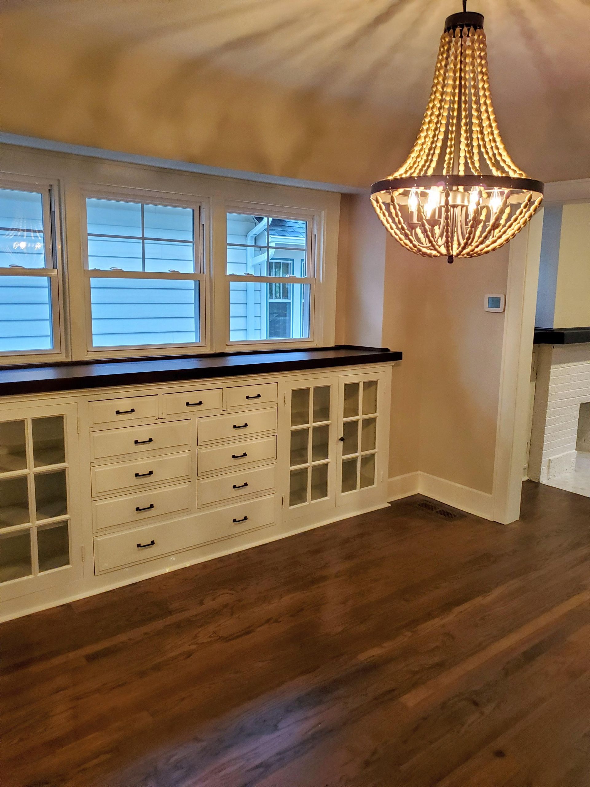 an empty room with a chandelier hanging from the ceiling