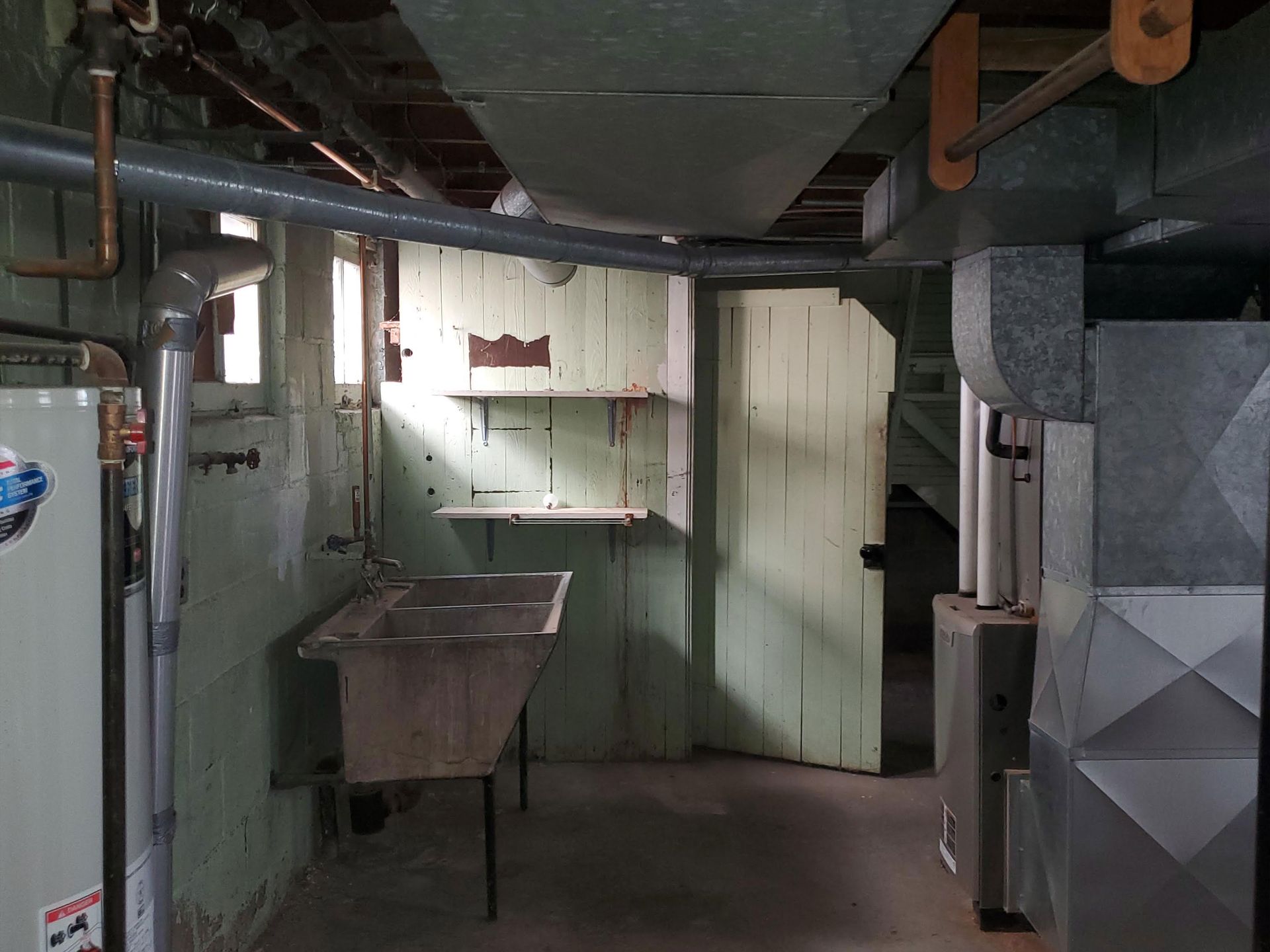 an empty room with a window and a light on the ceiling .