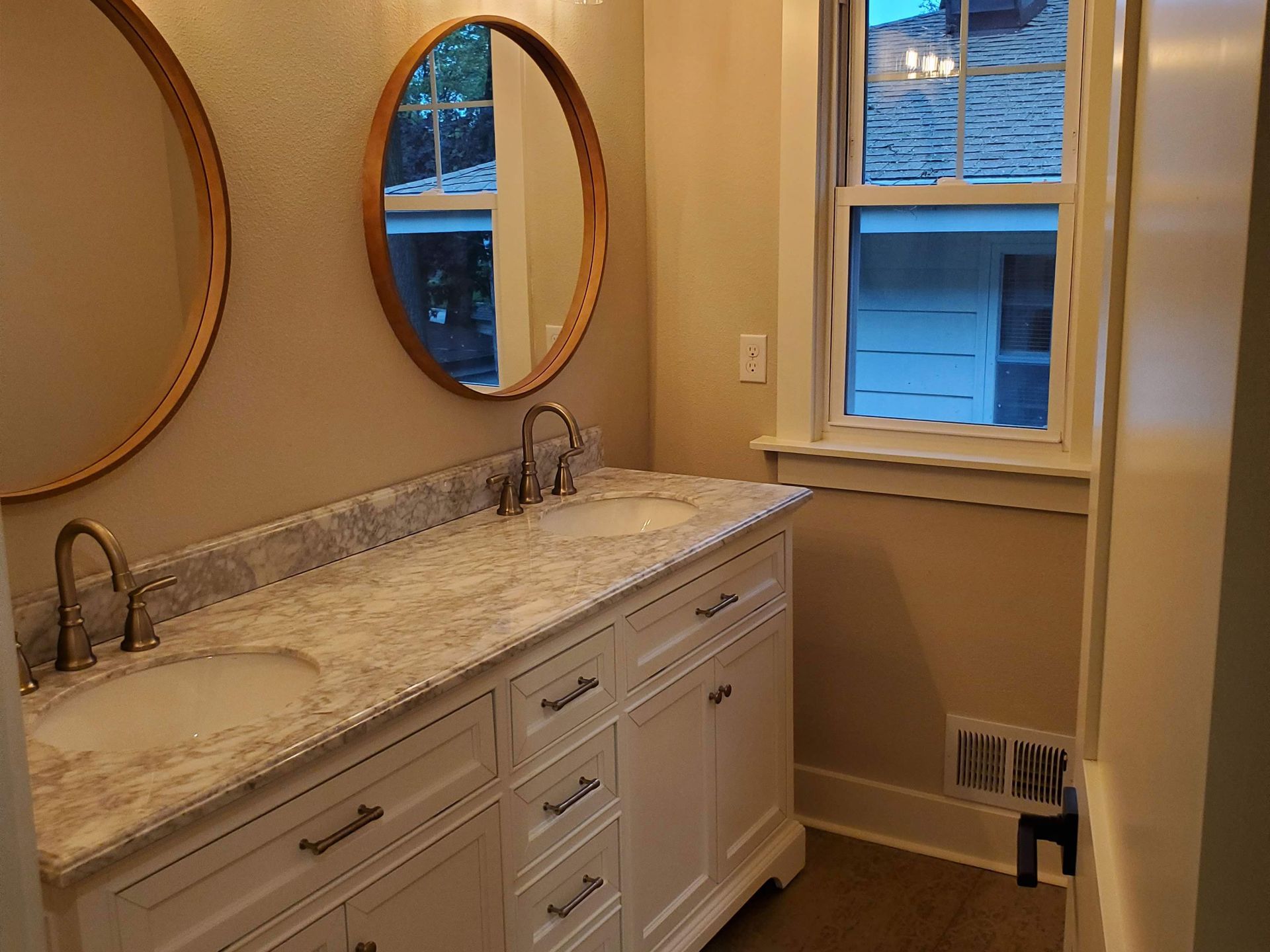 a bathroom with two sinks and two mirrors .