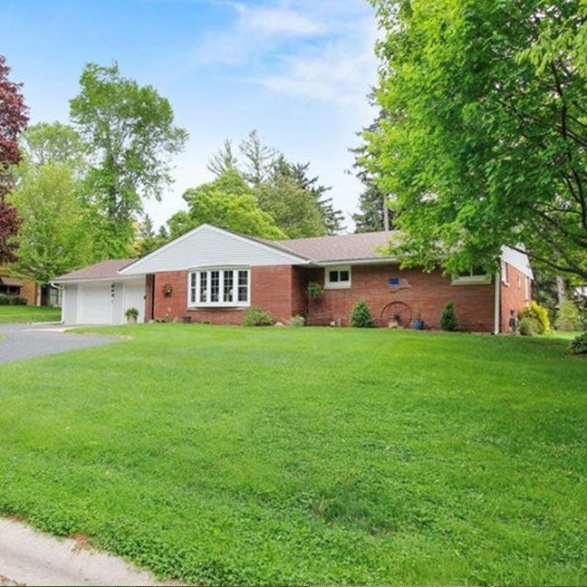 a house with a porch and stairs in front of it