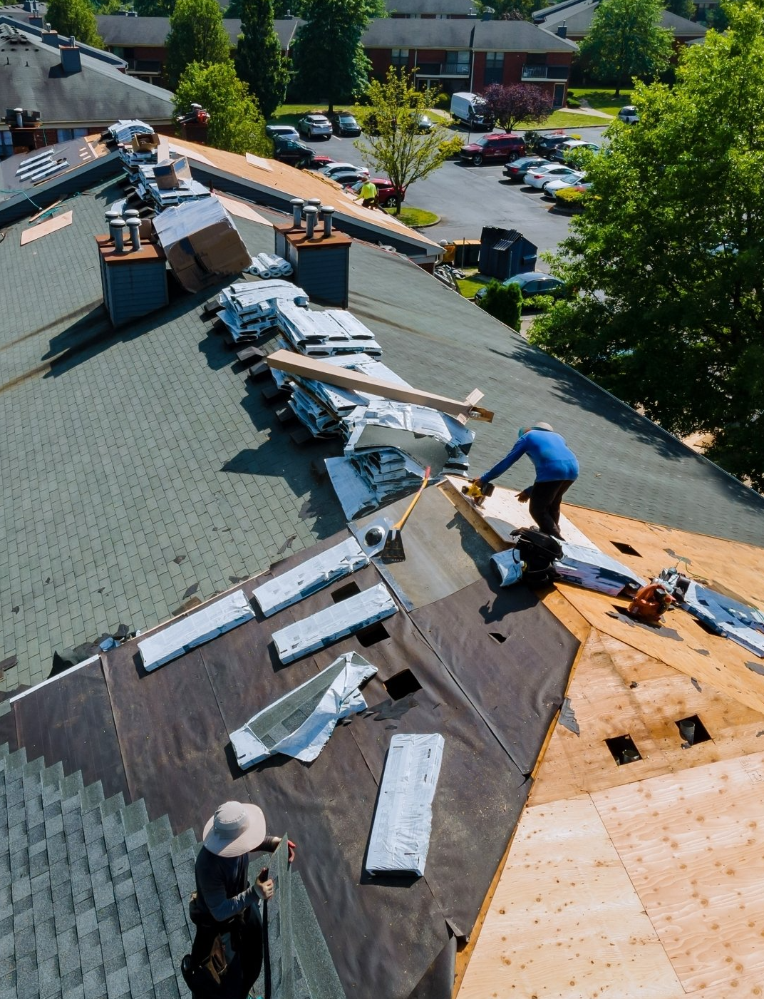 a worker installing shingles on a roof