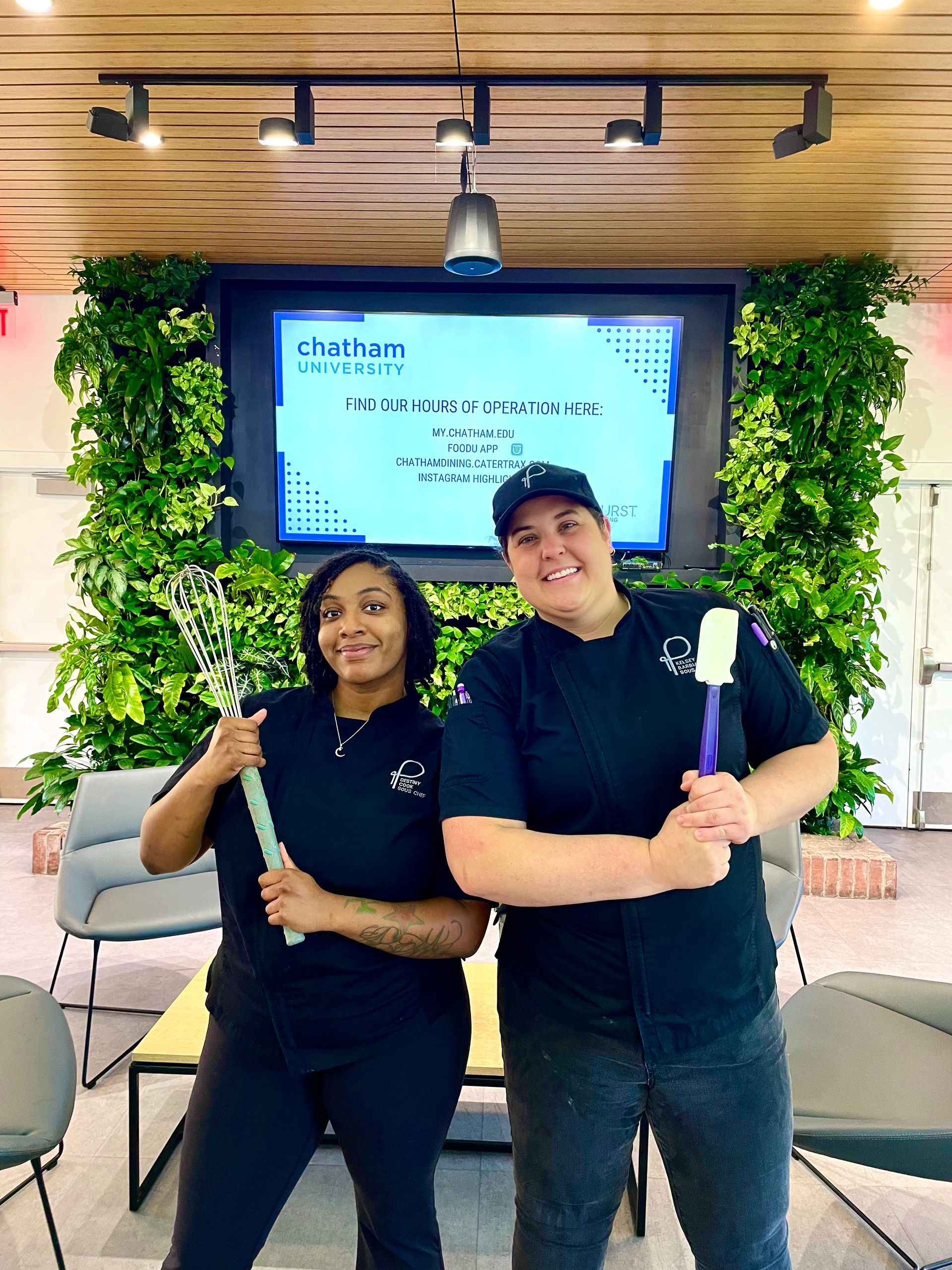 A man in a chef 's hat is posing for a picture with two other chefs