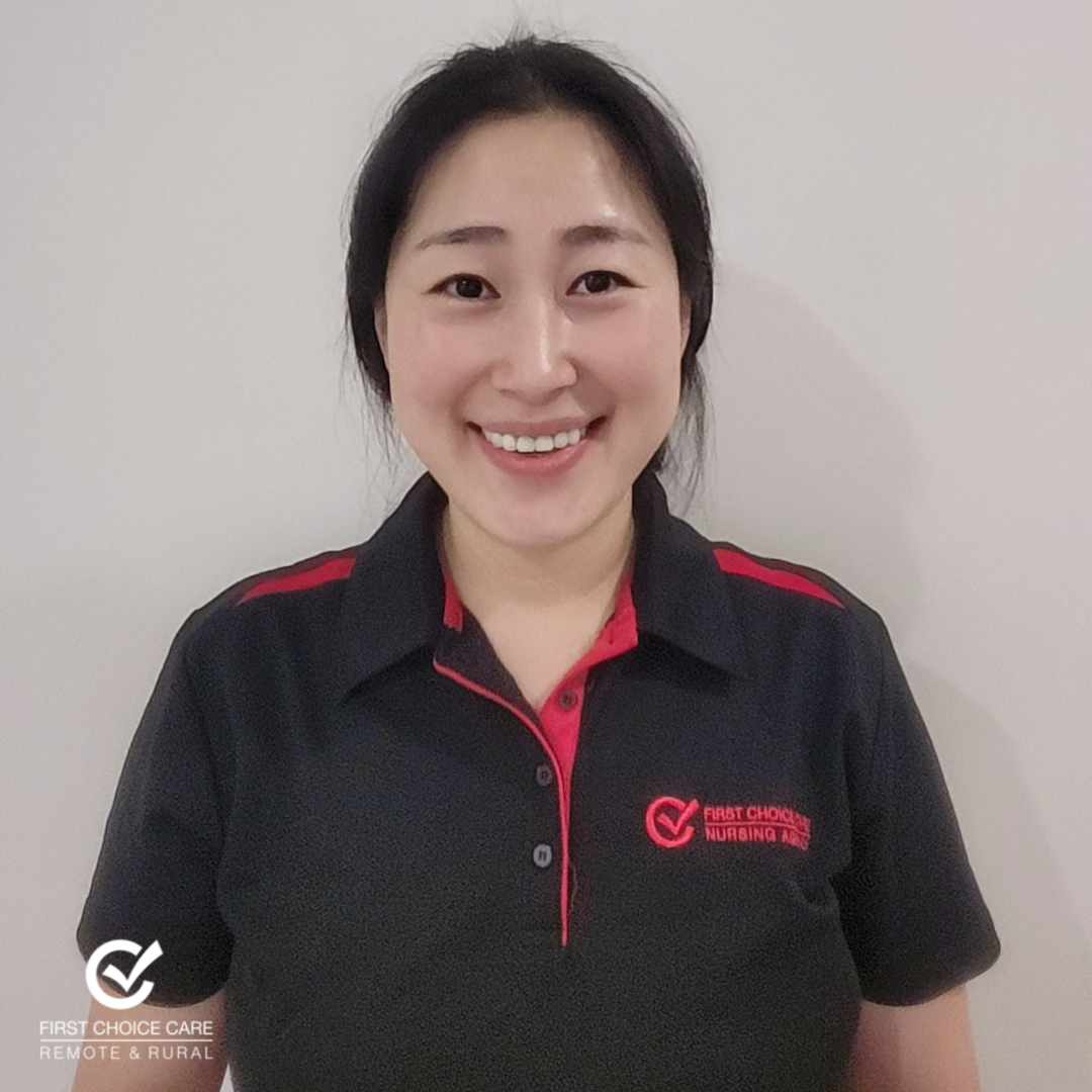 A woman wearing a black shirt with a red check mark on it