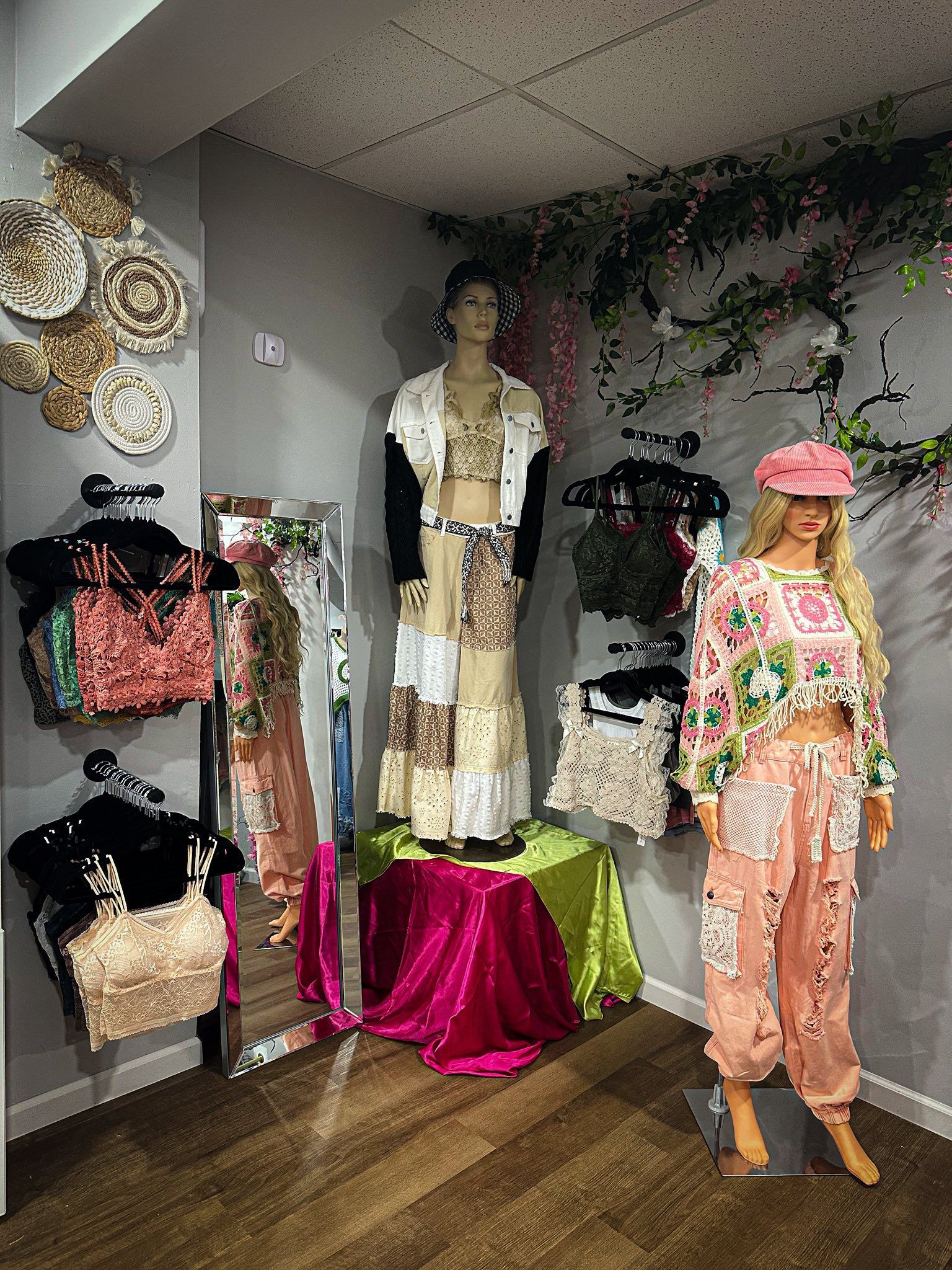Clothing store interior with mannequins displaying colorful outfits.