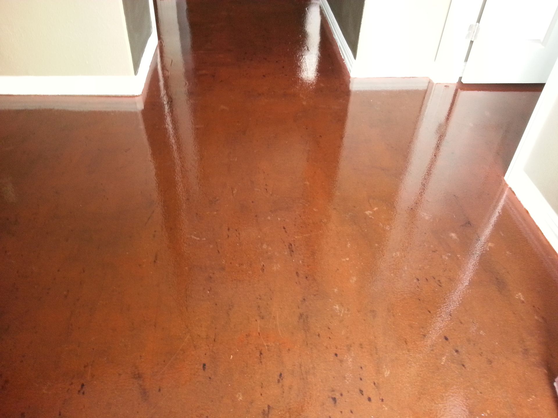 A Hallway with A Brown Floor and White Trim
