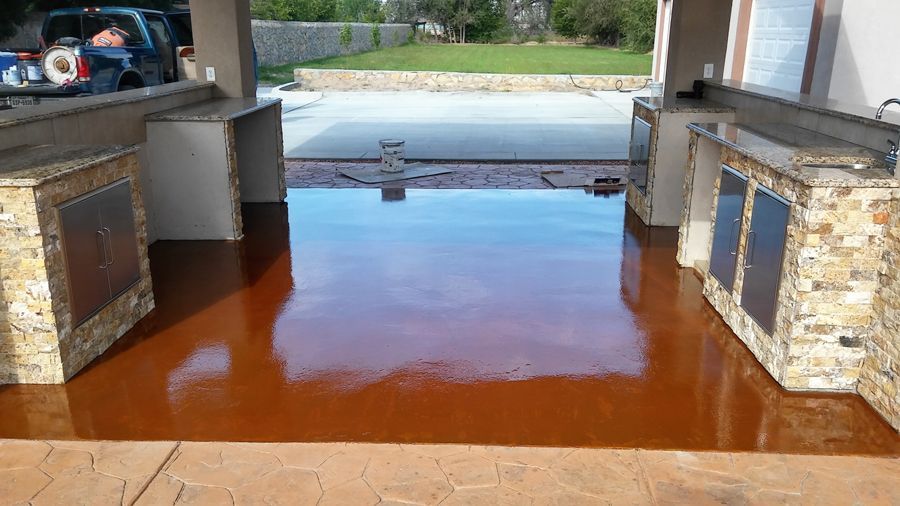 A Patio with A Concrete Floor and A Stone Wall.