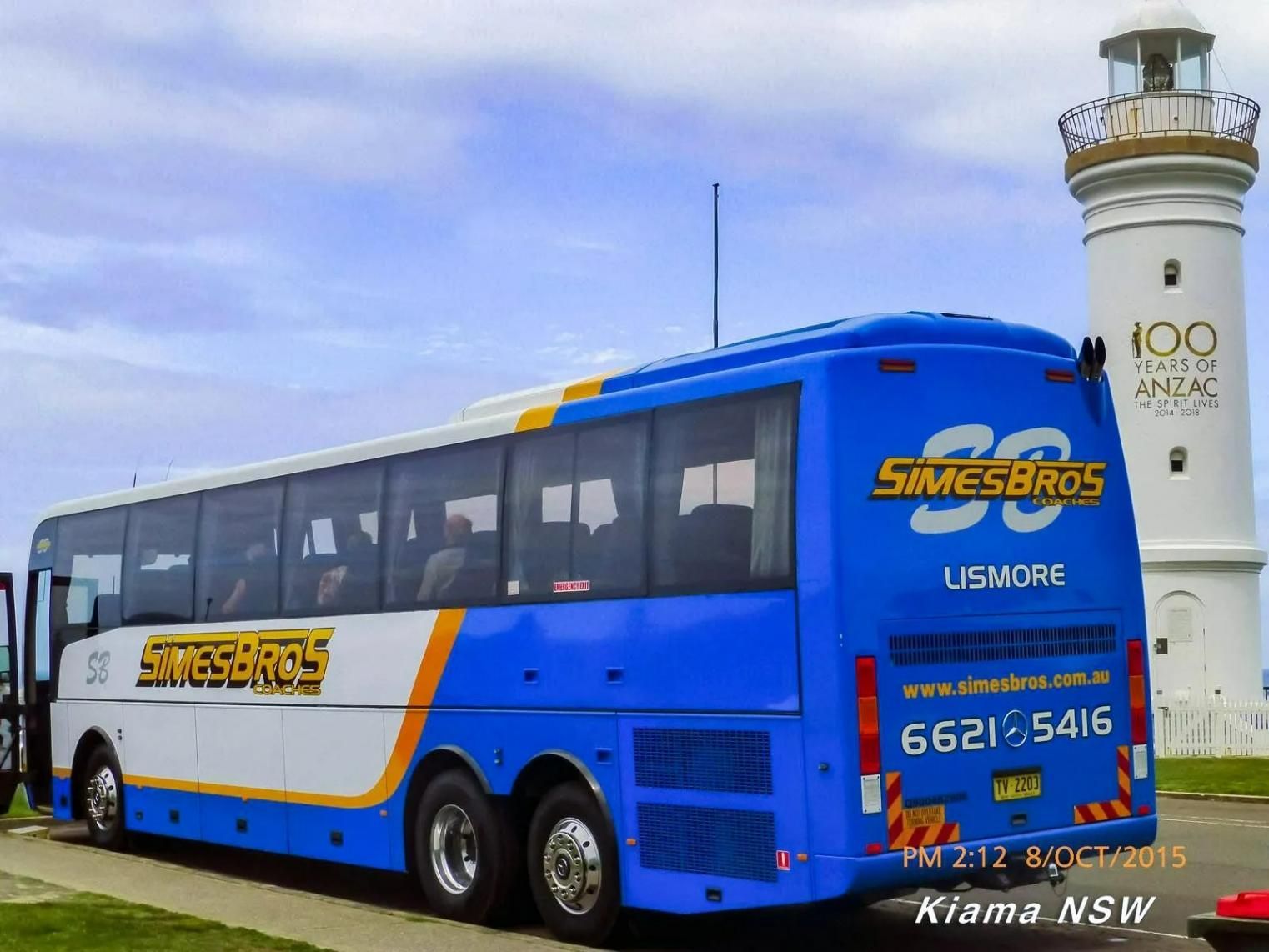 A Blue and White Bus Is Parked in Front of A Lighthouse — Simes Bros Coaches in South Lismore, NSW